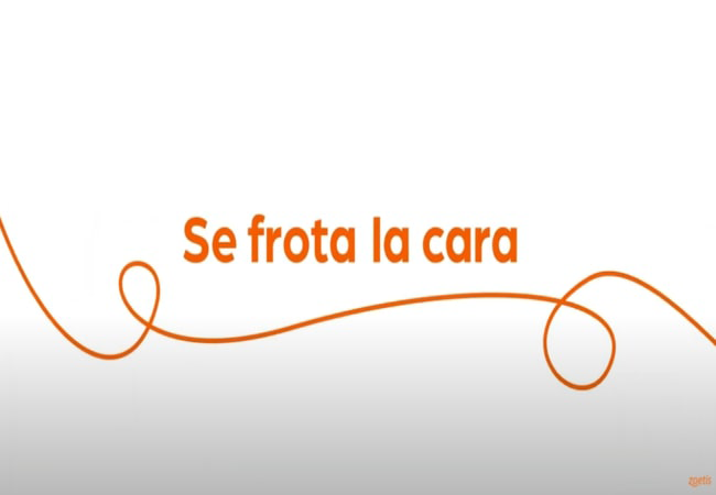 Texto "Se frota la cara" con espiral naranja sobre fondo blanco.